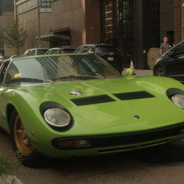 A green sports car parked on the street.