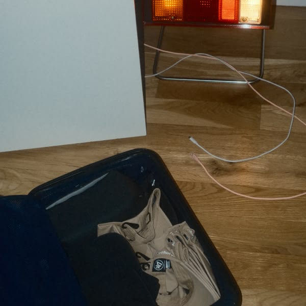 A blue suitcase with clothes in it.