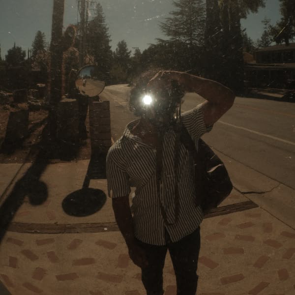 A man taking a picture of himself in front of a mirror.