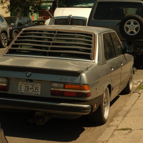 A BMW car is parked on the side of the road.