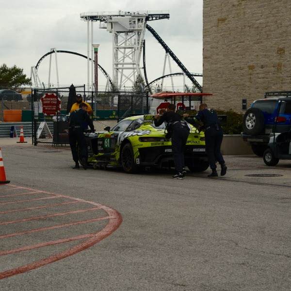 A group of men working on a car.