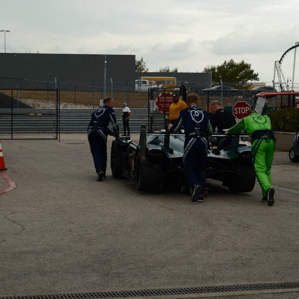 A group of men working on a race car.