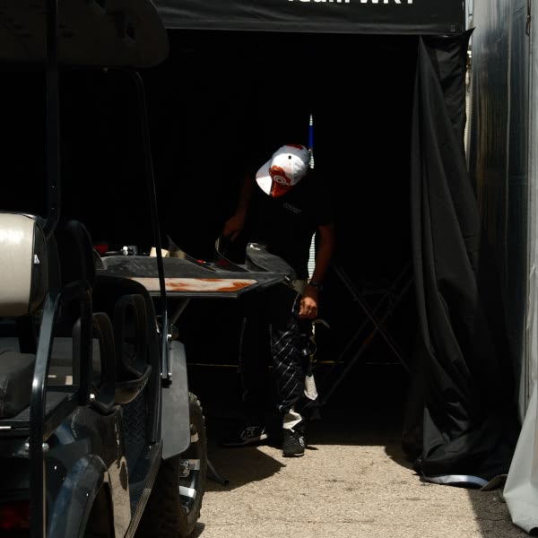 A man is standing in front of a tent.