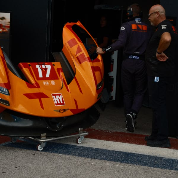 A red and orange race car with the number 17 on it.