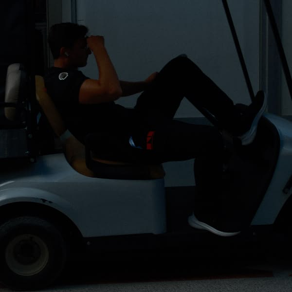 A man sitting in a golf cart.