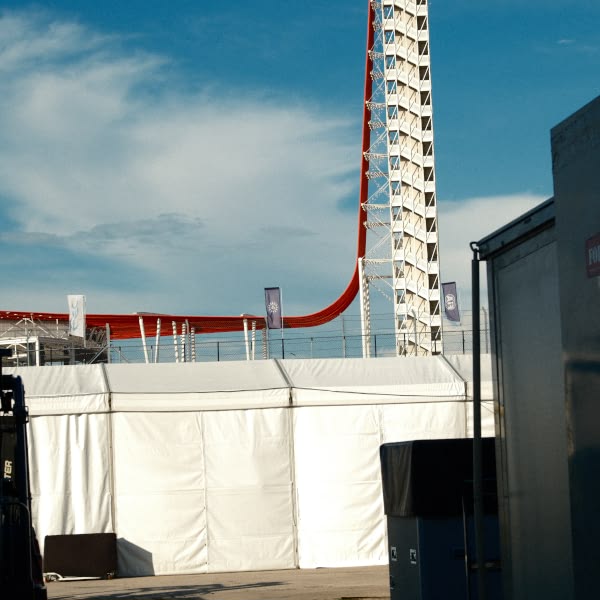 A large white tent with a red stripe.
