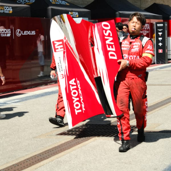 A man holding a red and white sign.
