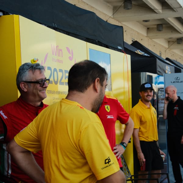 A group of men wearing yellow shirts and black shorts.