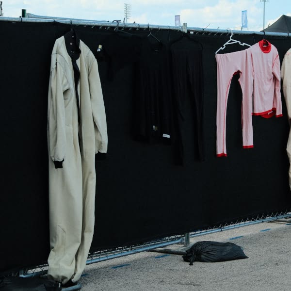 A fence with clothes hanging on it.
