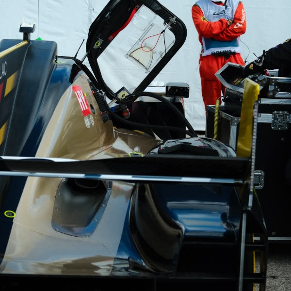 A man standing in front of a car.