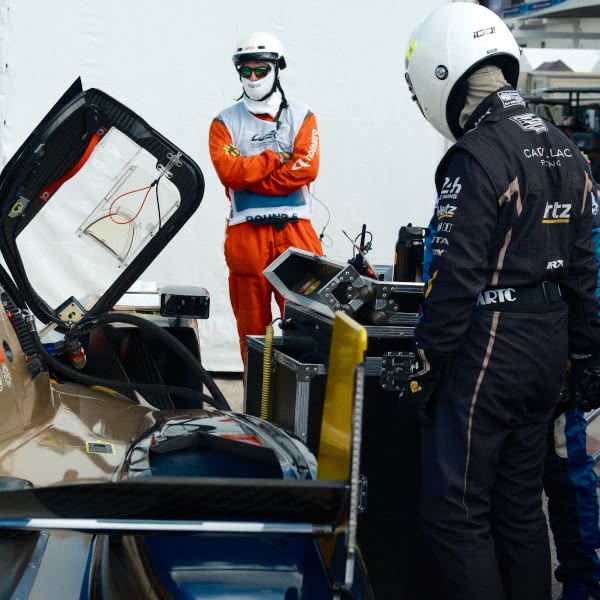 A group of people working on a car.