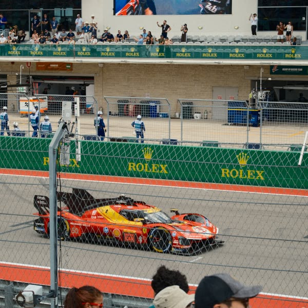 A red race car on a track.