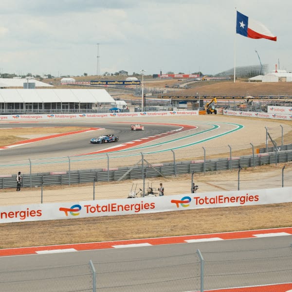 A race track with a flag and a sign that says Total Energies.
