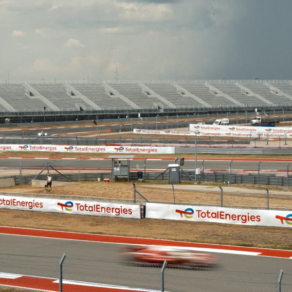 A red car is racing on a track.