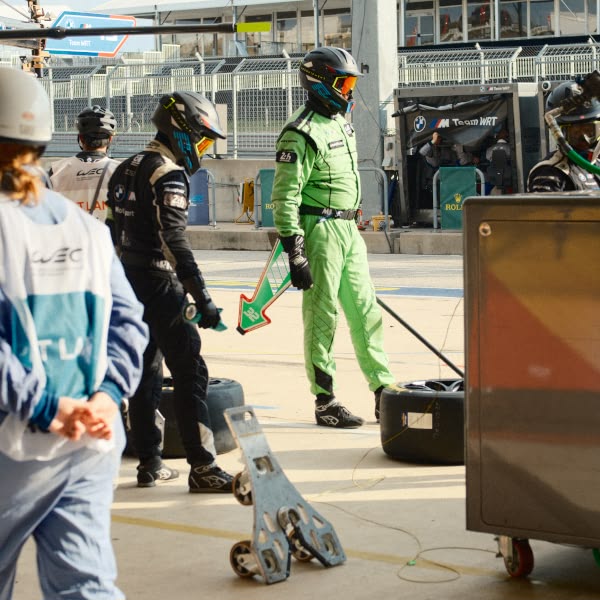 A man in a green suit holding a green object.
