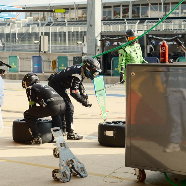 A group of men working on a race car.