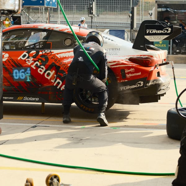 A man is working on a race car.