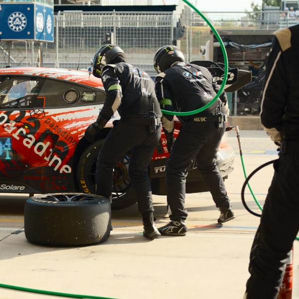 Two men working on a race car.