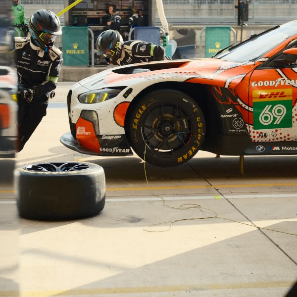 A tire is being changed on a race car.