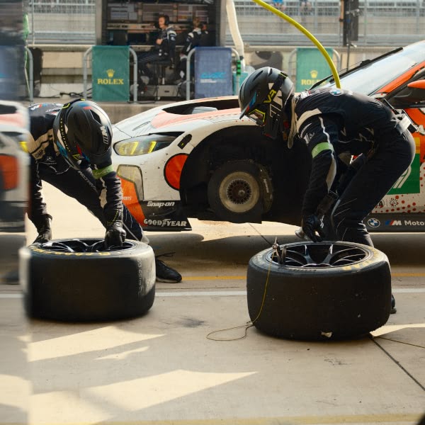 Two men working on a tire.