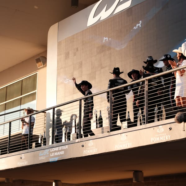A group of people standing on a balcony.