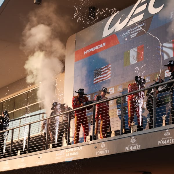 A group of people standing on a balcony.