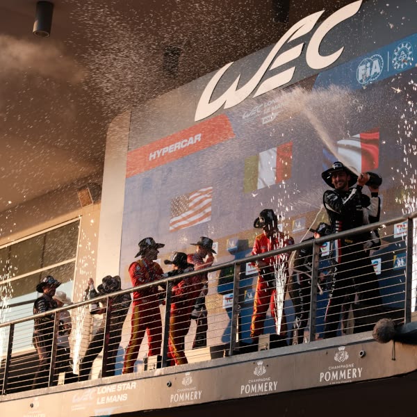 A group of people celebrating on a balcony.