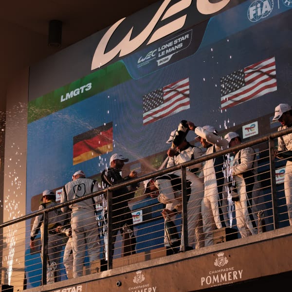 A group of people standing on a balcony.