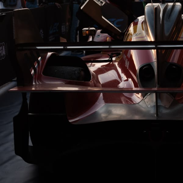 A red race car with a man inside.