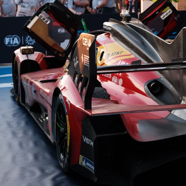 A red racing car with the hood open.