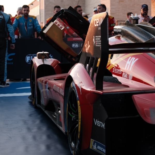 A red car with the hood open.