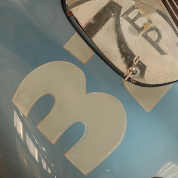 A blue car with a 32 on the front.
