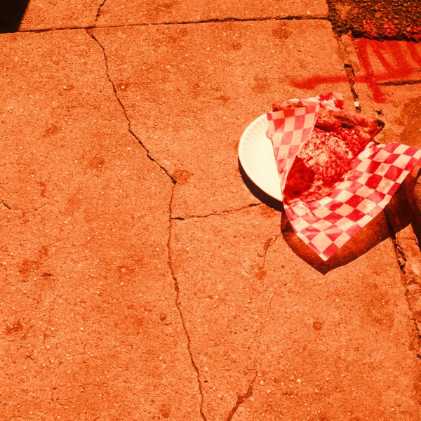 A white plate with a slice of pizza on it.