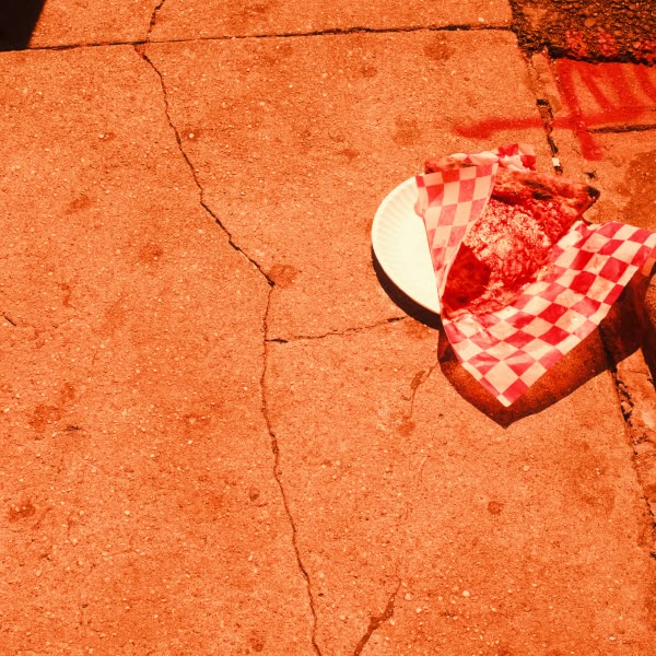 A white plate with a slice of pizza on it.