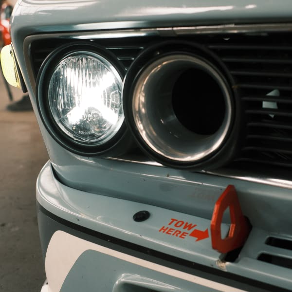 A blue car with a tow sign on the front.