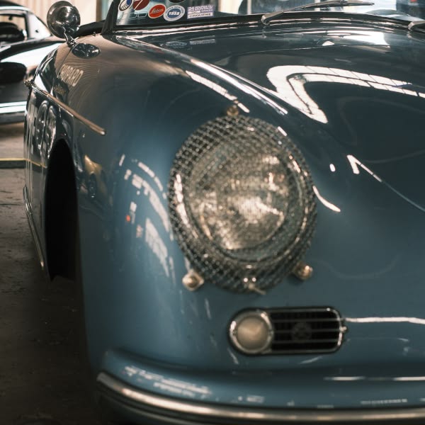 A blue car with a chrome grill.