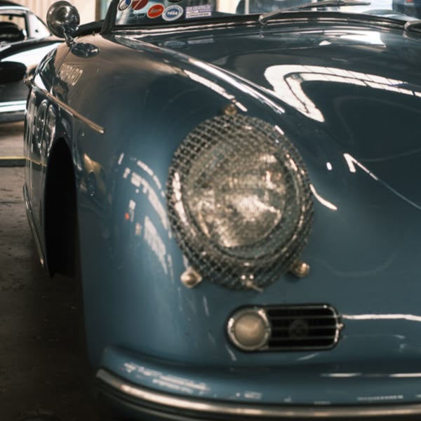 A blue car with a chrome grill.