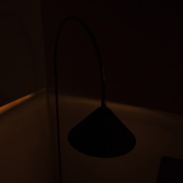 A black lamp with a metal pole.