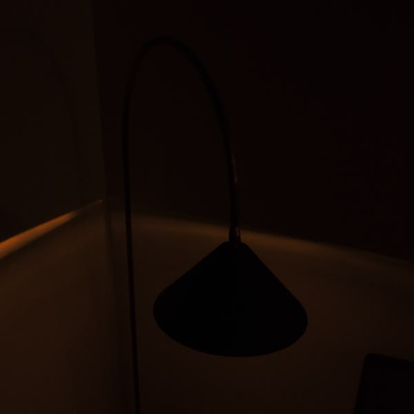 A black lamp with a metal pole.