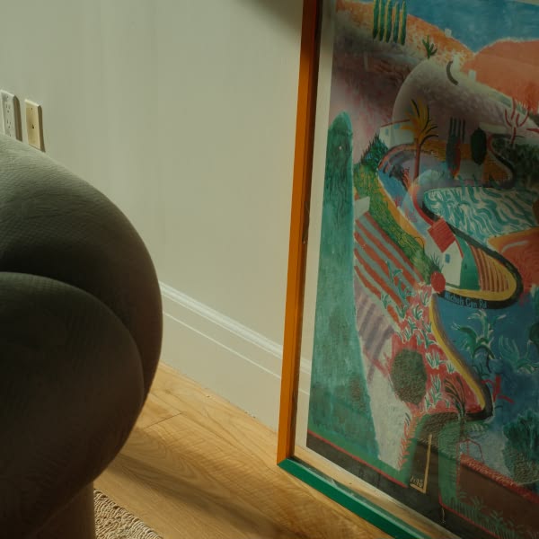 A painting of a house on a wall.