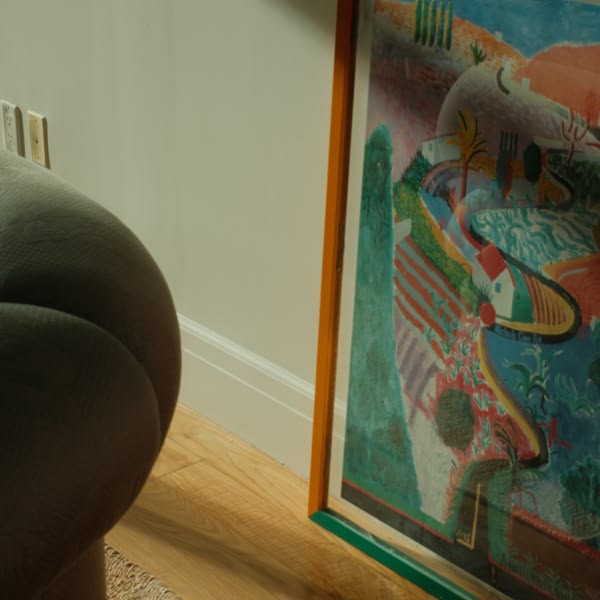 A painting of a house on a wall.