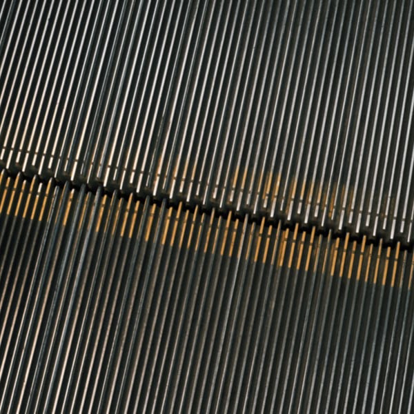 A metal staircase with yellow stripes.
