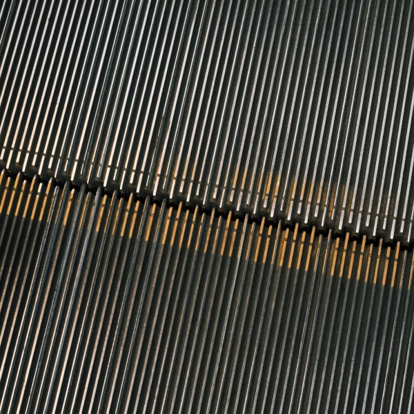 A metal staircase with yellow stripes.