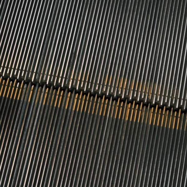 A metal staircase with yellow stripes.