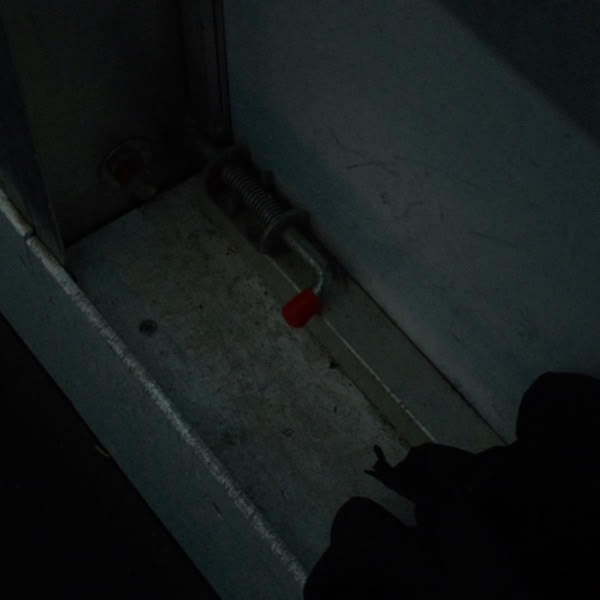 A black glove on a white wall.
