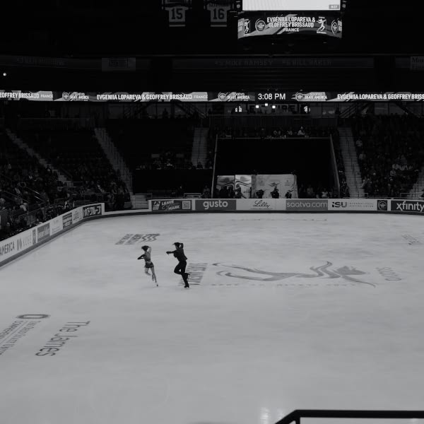A man and a girl skating on ice.