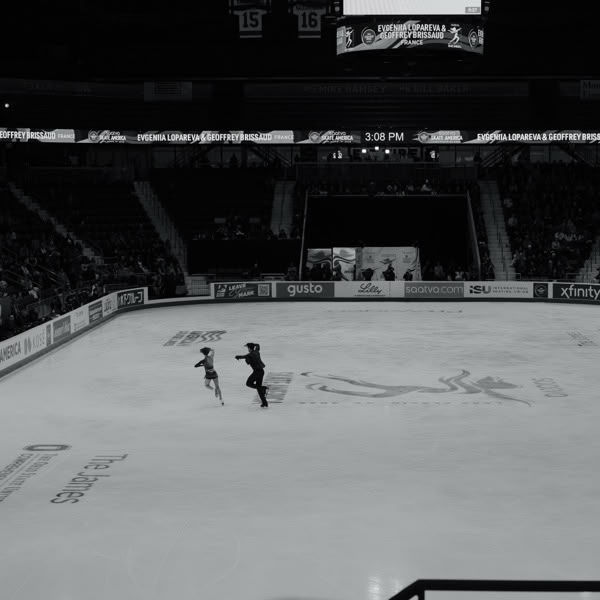 A man and a girl skating on ice.
