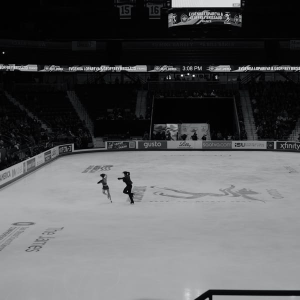A man and a girl skating on ice.