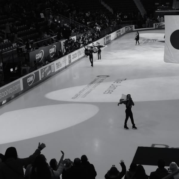 A man holding a flag on ice.