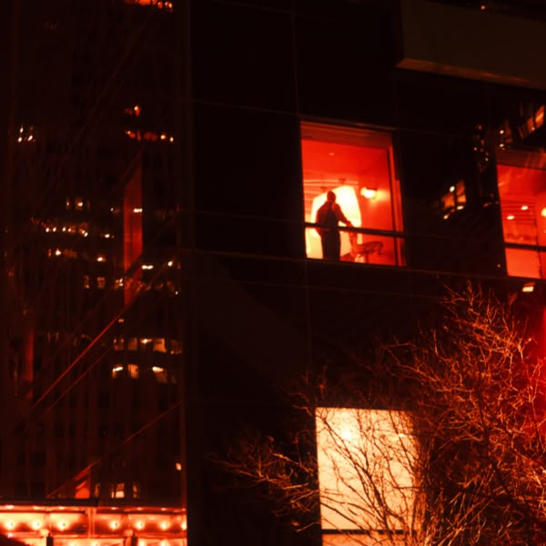 A man standing in a room with a window.